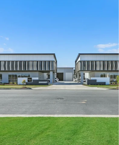 Symmetrical commercial buildings with green lawn